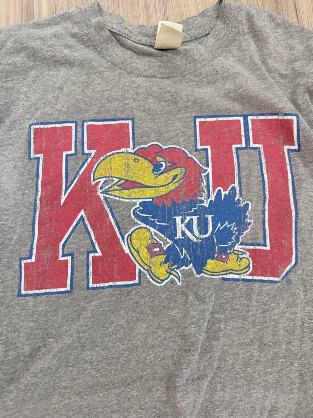 Agenda Gray Tee with Red, Blue and Yellow Jayhawk Graphic